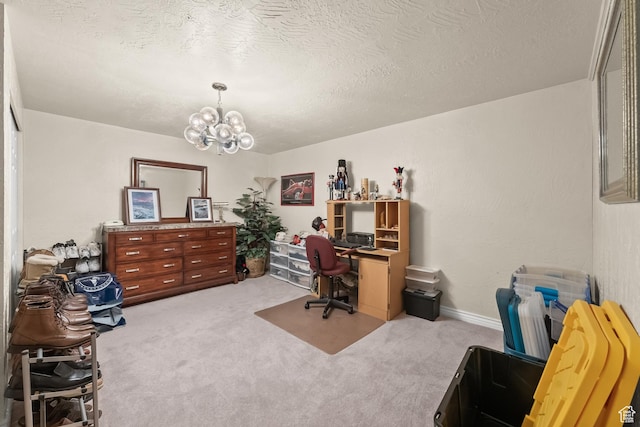 office area featuring a textured ceiling, carpet flooring, a notable chandelier, and baseboards
