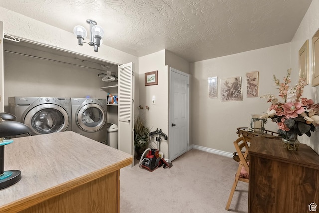 washroom with baseboards, washer and dryer, laundry area, a textured ceiling, and light colored carpet