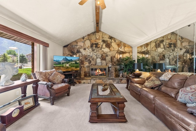 carpeted living area featuring ceiling fan, vaulted ceiling with beams, and a fireplace