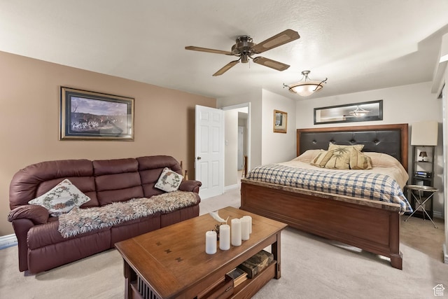 bedroom featuring baseboards and light colored carpet