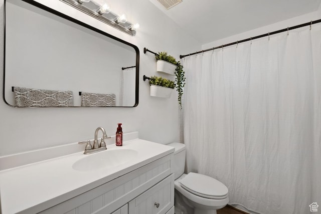 full bath with vanity, visible vents, and toilet