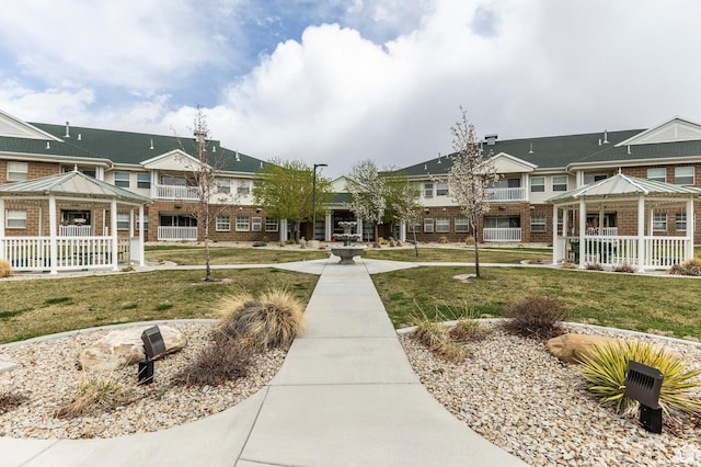 view of community with a gazebo, a residential view, and a lawn