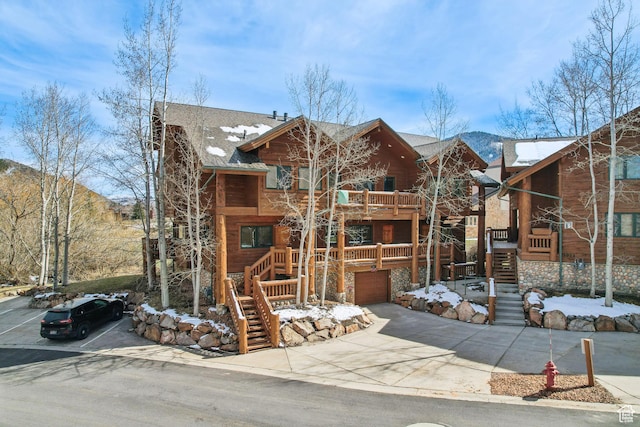 3931 Timber Wolf Ln Unit 7C, Park City, UT 84098 - view of front of home with a garage, roof with shingles, concrete driveway, and stairway