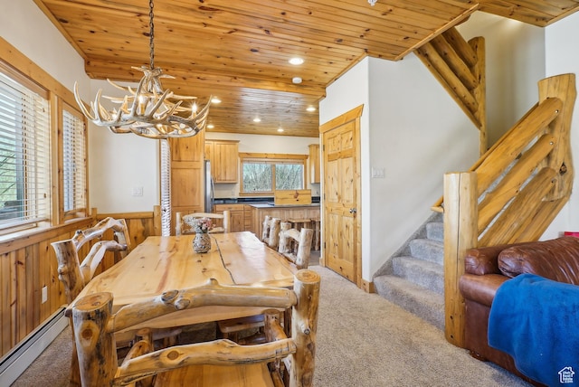 3931 Timber Wolf Ln Unit 7C, Park City, UT 84098 - dining area with a baseboard radiator, a chandelier, light carpet, and wood ceiling