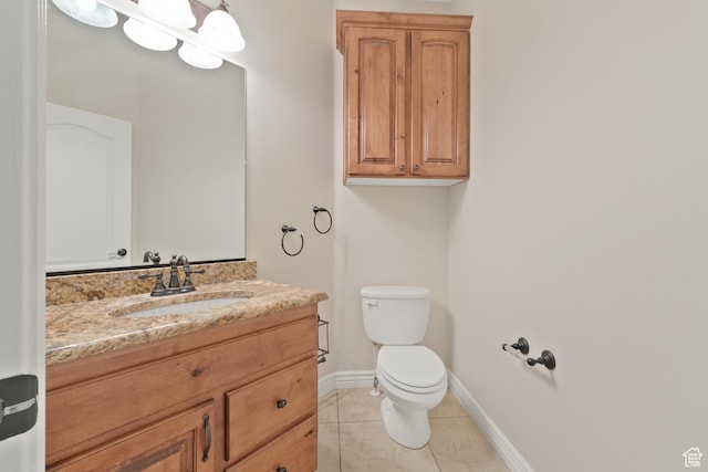 bathroom featuring tile patterned flooring, toilet, vanity, and baseboards