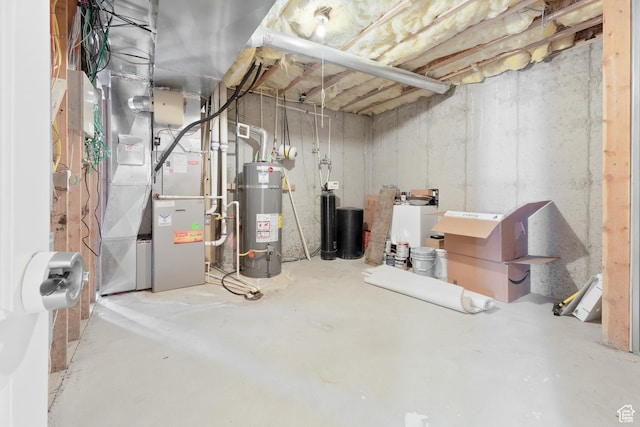 unfinished below grade area featuring heating unit and gas water heater