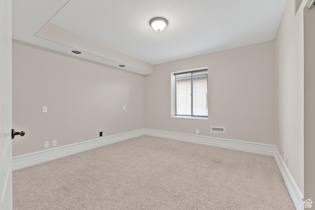 carpeted empty room with baseboards and visible vents