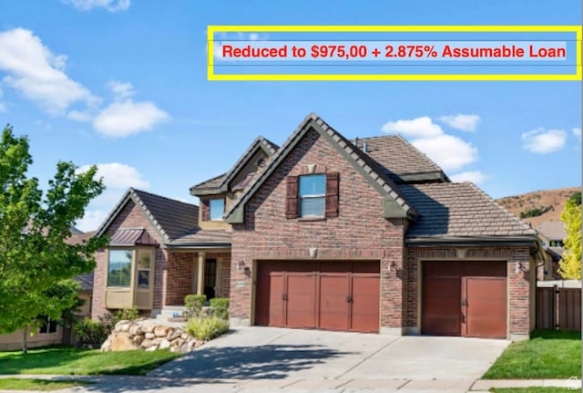 2168 W Aspen Wood Loop, Lehi, UT 84043 - view of front of property with brick siding, concrete driveway, and a garage