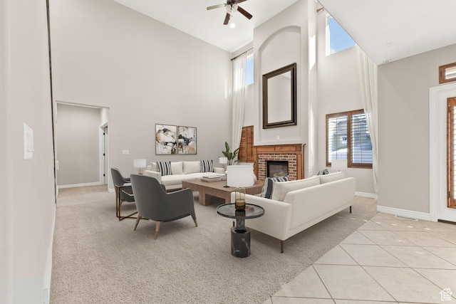 living room with baseboards, high vaulted ceiling, ceiling fan, and a healthy amount of sunlight