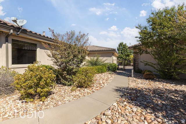 1285 Summerwood Cir, Santa Clara, UT 84765 - view of property exterior featuring a tiled roof, a gate, and stucco siding