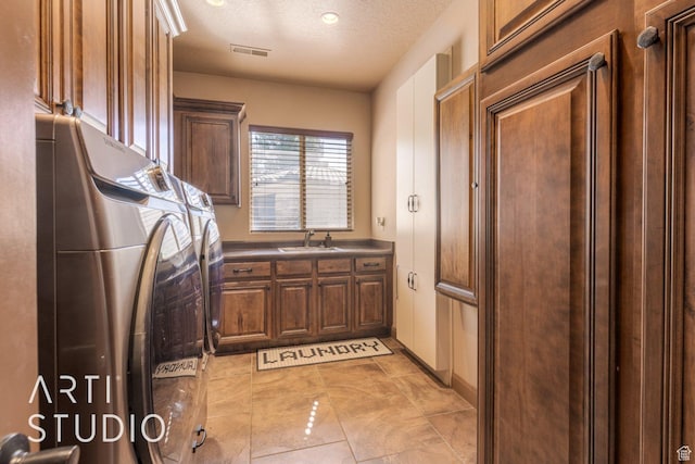 1285 Summerwood Cir, Santa Clara, UT 84765 - laundry room with a textured ceiling, visible vents, washing machine and clothes dryer, a sink, and cabinet space