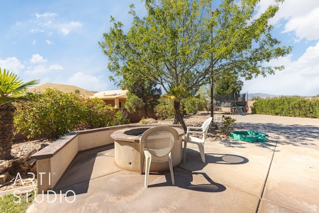 1285 Summerwood Cir, Santa Clara, UT 84765 - view of patio / terrace with a mountain view, an outdoor fire pit, and a trampoline