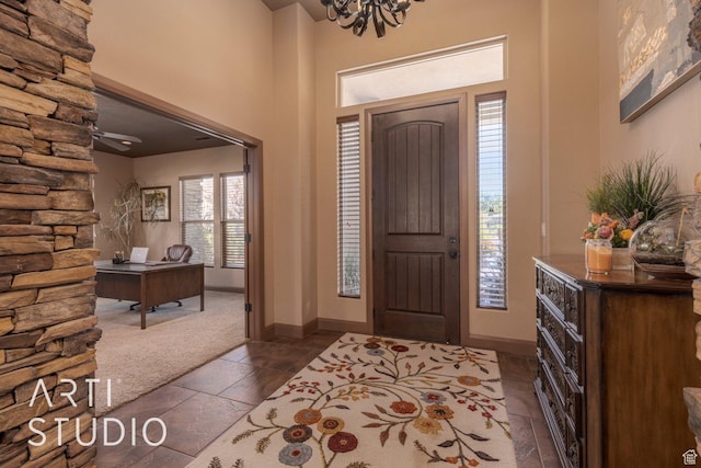 1285 Summerwood Cir, Santa Clara, UT 84765 - foyer entrance featuring dark colored carpet, a towering ceiling, an inviting chandelier, and a healthy amount of sunlight