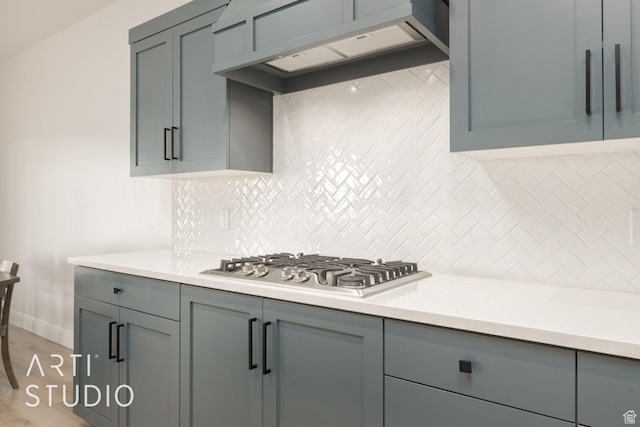 3419 E 3050 S, St George, UT 84790 - kitchen featuring tasteful backsplash, gray cabinets, premium range hood, light countertops, and stainless steel gas cooktop