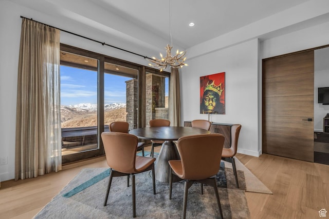 2178 E Lone Peak Ln, Kamas, UT 84036 - dining space with light wood-type flooring, an inviting chandelier, and baseboards