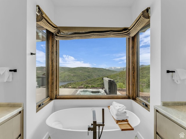 2178 E Lone Peak Ln, Kamas, UT 84036 - bathroom with vanity, a freestanding bath, a mountain view, and baseboards