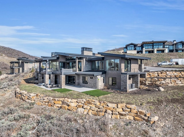 2178 E Lone Peak Ln, Kamas, UT 84036 - rear view of property with a patio area, stone siding, and a balcony