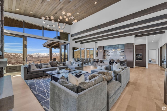 2178 E Lone Peak Ln, Kamas, UT 84036 - living area featuring a notable chandelier, a mountain view, light wood-style flooring, a high ceiling, and beamed ceiling
