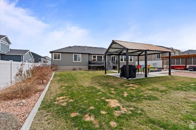 rear view of property with a patio area, a gazebo, a yard, and fence