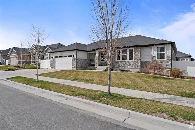 view of front of house featuring stone siding, a garage, fence, a front lawn, and driveway