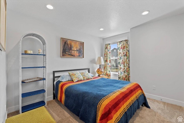 carpeted bedroom featuring baseboards, recessed lighting, and a textured ceiling
