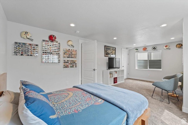 bedroom with light carpet, recessed lighting, and baseboards