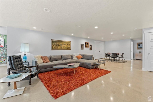 living room with recessed lighting, a textured ceiling, and baseboards