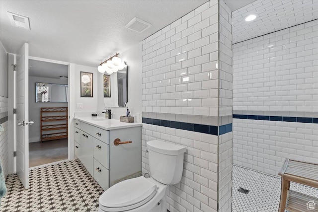 full bathroom with vanity, visible vents, a textured ceiling, and toilet