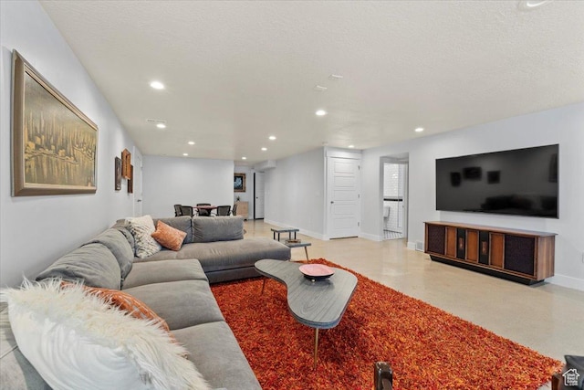 living room with baseboards, recessed lighting, and a textured ceiling