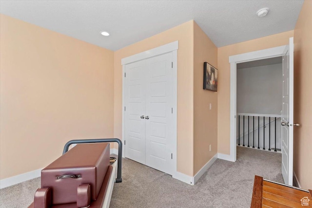 carpeted bedroom featuring baseboards, recessed lighting, and a textured ceiling