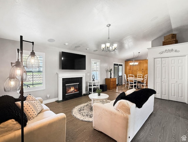 living room featuring a chandelier, dark wood-style floors, and plenty of natural light