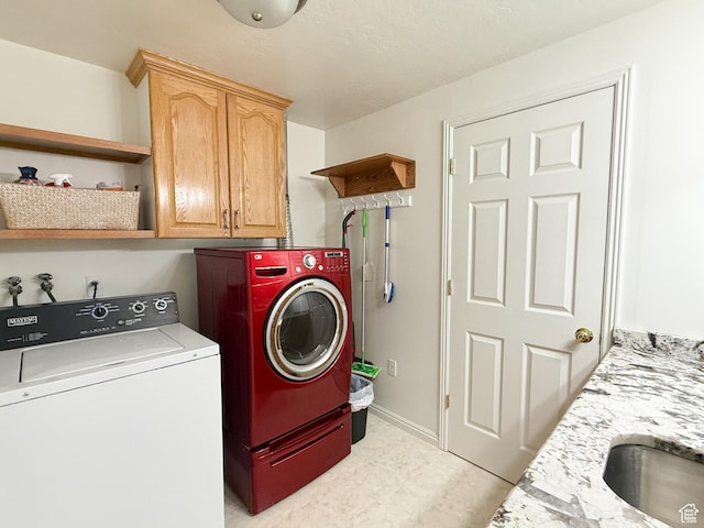 laundry room featuring cabinet space, washer and clothes dryer, and baseboards