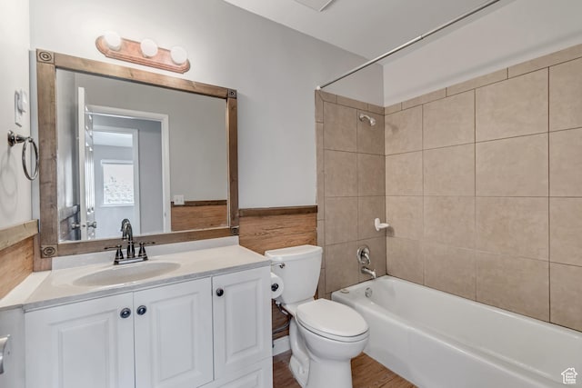 bathroom featuring vanity,  shower combination, toilet, and wood finished floors