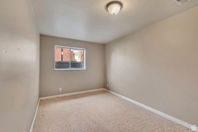 carpeted spare room with baseboards