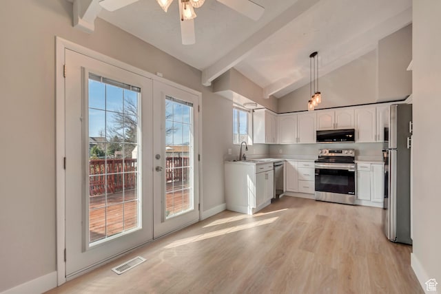 kitchen featuring stainless steel appliances, french doors, visible vents, and a sink