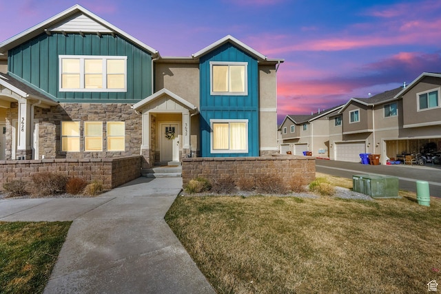 craftsman house with board and batten siding and a front lawn
