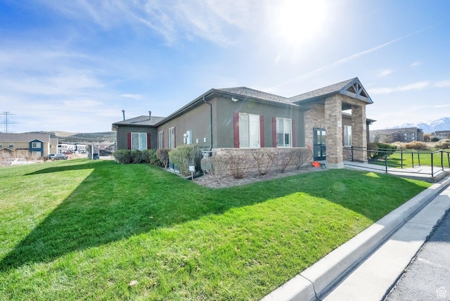 3632 E Sapphire Creek Ln N Unit 318, Eagle Mountain, UT 84005 - view of property exterior with a lawn and stone siding