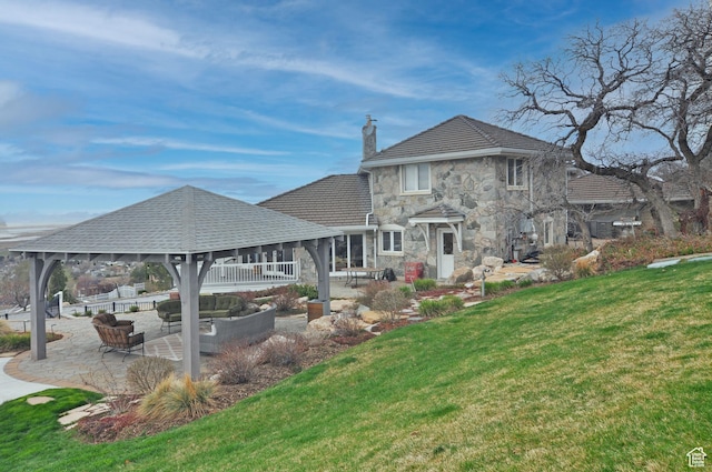 360 E 1825 N, Centerville, UT 84014 - rear view of property featuring stone siding, a lawn, a chimney, an outdoor living space, and a patio