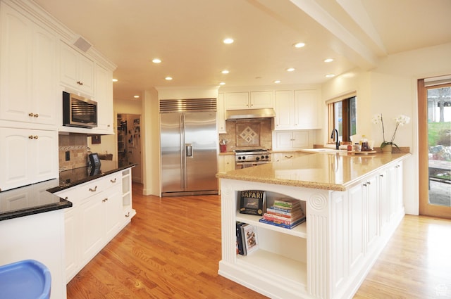 360 E 1825 N, Centerville, UT 84014 - kitchen featuring white cabinetry, under cabinet range hood, appliances with stainless steel finishes, light wood finished floors, and a sink