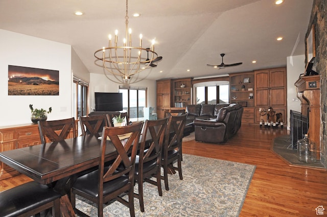 360 E 1825 N, Centerville, UT 84014 - dining space featuring ceiling fan with notable chandelier, a high end fireplace, wood finished floors, and a healthy amount of sunlight