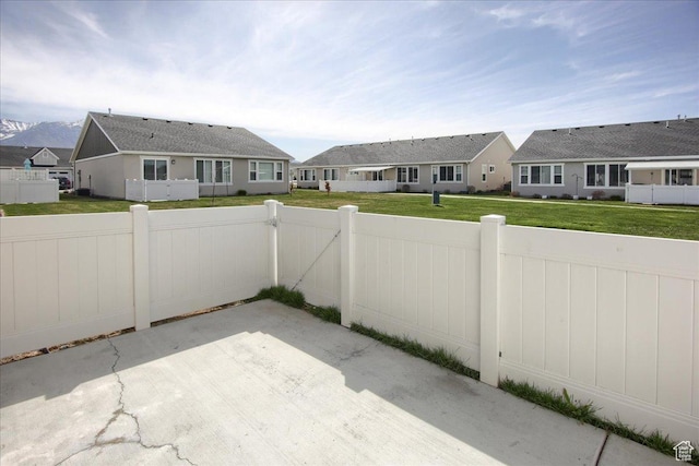 view of patio / terrace with a residential view, fence, and a gate