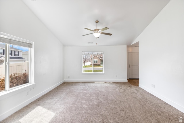 carpeted empty room featuring high vaulted ceiling, visible vents, baseboards, and ceiling fan