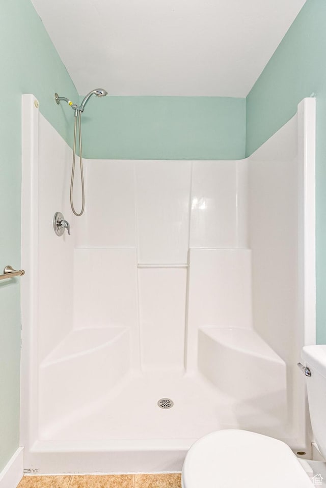 bathroom with toilet and a shower
