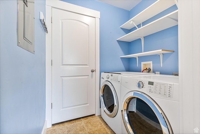 laundry area with laundry area, separate washer and dryer, and light tile patterned floors