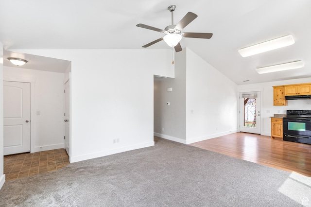 unfurnished living room with carpet, baseboards, a ceiling fan, and vaulted ceiling