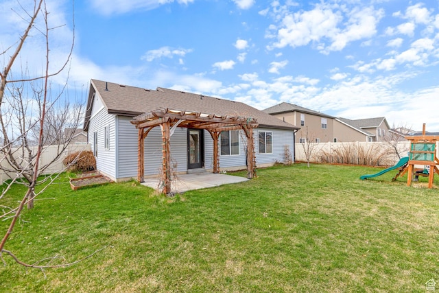 rear view of property with a pergola, a patio area, a yard, a fenced backyard, and a playground