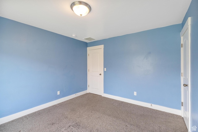 carpeted empty room with visible vents and baseboards