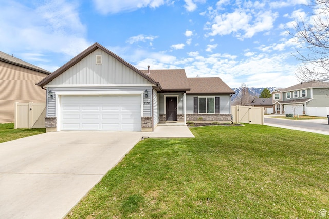 view of front of house featuring concrete driveway, a gate, a front yard, a garage, and fence