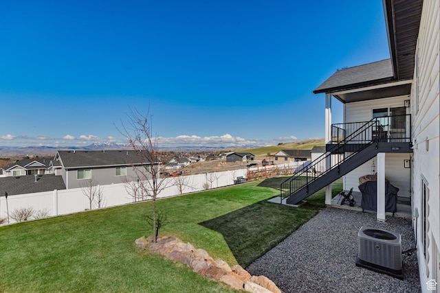 51 S 1250 E, Smithfield, UT 84335 - view of yard with central AC unit, a fenced backyard, a residential view, and stairs