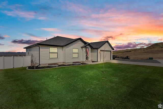 51 S 1250 E, Smithfield, UT 84335 - view of front of house with concrete driveway, an attached garage, fence, and a lawn